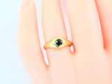 an image of a gold ring with an evil eye on it