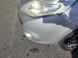 a close up of a car ' s headlight on the street
