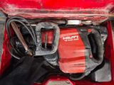 a red tool box with tools in it on the ground