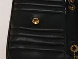 a black purse with gold hardware on the inside of it