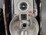 an old camera sitting on top of a table