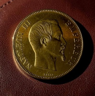 a close up of a coin sitting on top of a brown bag