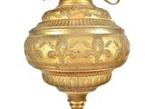 a gold vase with a bird on top of it