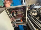 a man that is holding a box with wires in it