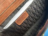 a close up of a purse with a leather handle