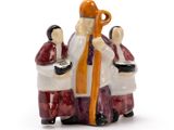 a figurine of a man and a woman sitting on a bench