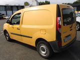 a yellow van parked in a parking lot next to other cars