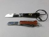 two knives and a knife holder on a table