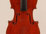 an old violin with a bow hanging from it ' s back
