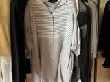 a rack of clothes and a pair of shoes in a room