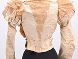 an image of a mannequin dress with ruffled sleeves and a black skirt