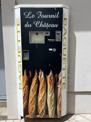 a vending machine that sells baguets outside of a building