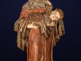 a statue of a woman holding a skull in her hands