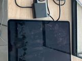 a tablet computer sitting on top of a wooden table