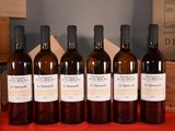 six bottles of wine are lined up on a red table