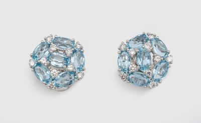 a pair of blue topaze and diamond earrings