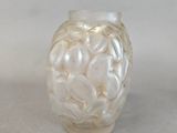 a glass vase that has a lot of shells in it