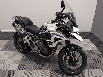 a motorcycle that is parked on a checkered floor