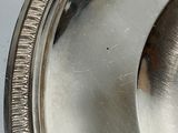 a close up of a silver plate on a table