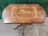 a wooden table with a decorative design on top of it