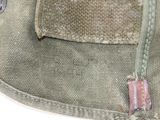 a close up of a bag with a button on it