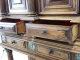 a wooden cabinet with drawers and a mirror in it