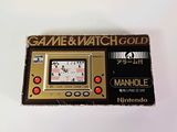 an image of a game and watch gold game in a cardboard box