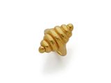 a close up of a gold shell on a white background