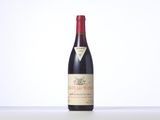 a bottle of red wine sitting on top of a table