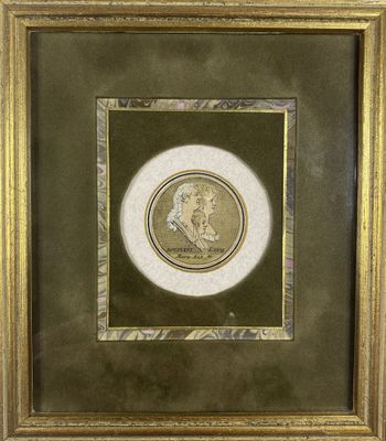 a gold framed picture of a portrait of a man in profile