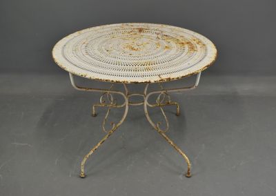 an image of a white table with a round top on a gray floor