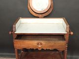 a small wooden table with a mirror on top of it