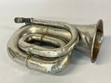a silver trumpet that is sitting on a table
