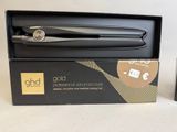 a black box with a black hair straightener in it