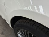 a close up of a tire on a white car