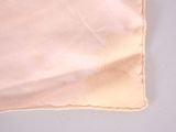 a piece of cloth on a table with a pair of scissors on it