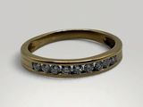a close up of a gold ring with black diamonds on it