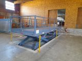 a picture of a blue lift truck in a warehouse