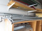 a shelf with a bunch of metal pipes on top of it