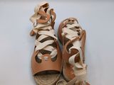 tan leather sandals with laces on the toes and a lace on the sole