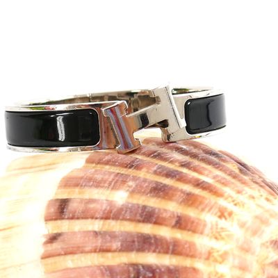 black and white bracelet with a silver clasp on a seashell