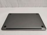 the back of a laptop computer sitting on top of a white surface