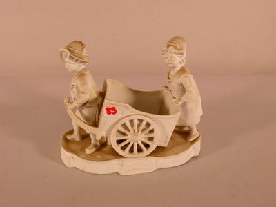 a figurine of a man and a woman in a carriage