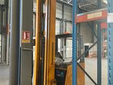 a forklift in a warehouse with pallets on the floor