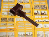an old photo of a hammer on top of a pile of old photos