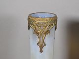 a glass vase with a gold decoration on it