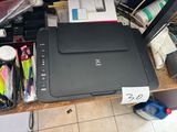 a printer sitting on top of a wooden desk
