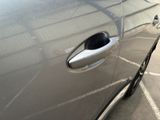a close up of a car door handle with a hole in it