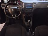 the interior of a small car with a steering wheel and dashboard