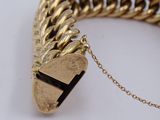 an image of a gold chain bracelet with a heart charm